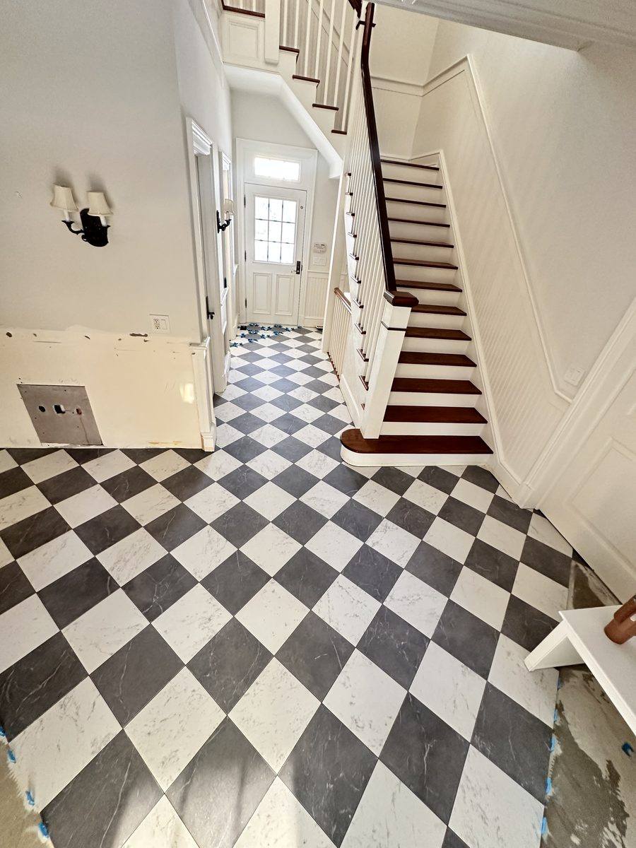Checkerboard tile floor at a staircase entry