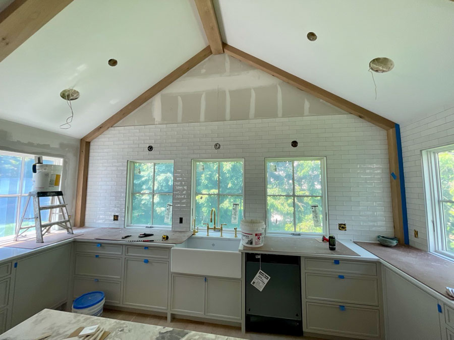 Kitchen Backsplash installed using white ceramic tiles arranged in a 1/2 offset pattern