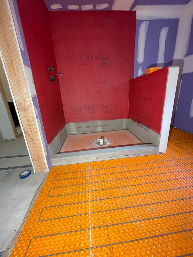 Yellow colored mat floor heating system is installed first before the bathroom tile flooring