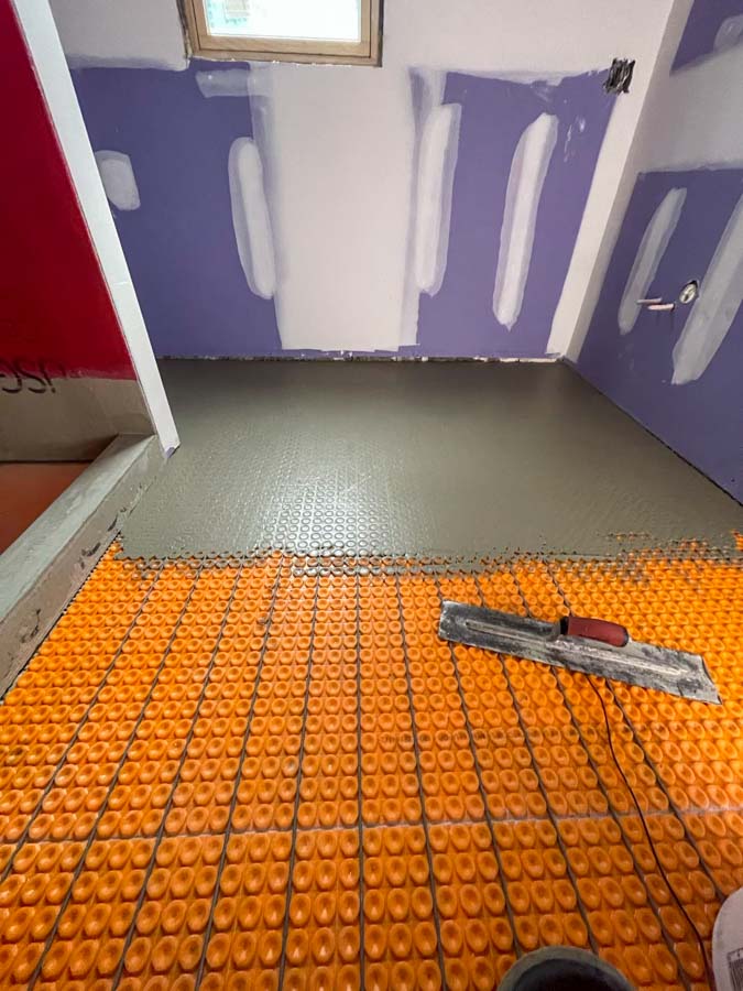 Prior to tile installation, heat mats are installed beneath the flooring