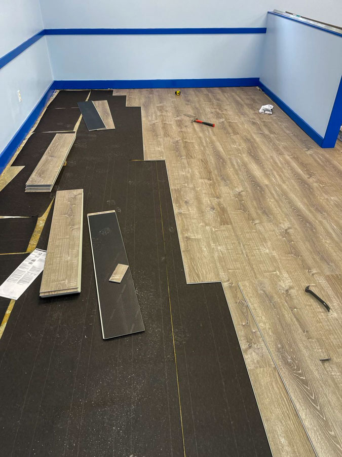 Ongoing installation of white oak vinyl tiles flooring