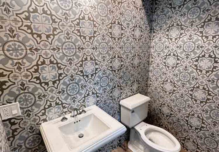 Powder Room Remodeled with patterned porcelain tiles for wall