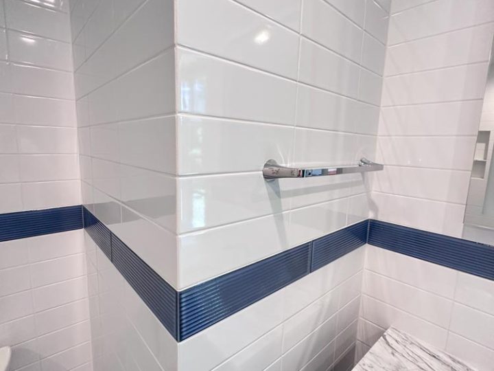 Bathroom Wall Glossy Finish Porcelain Tile with blue tile accent and steel bars for mobility aid